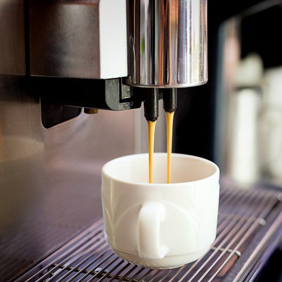 espresso running into small white cup