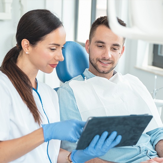 Woman going over paperwork with male patient