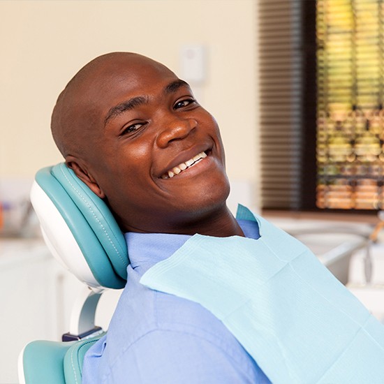 Man laying back in exam chair for dental checkup
