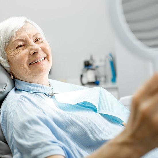 Older woman smiling after same day dental restoration