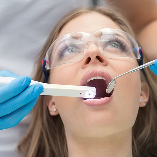 Woman having smile examined by intraoral camera