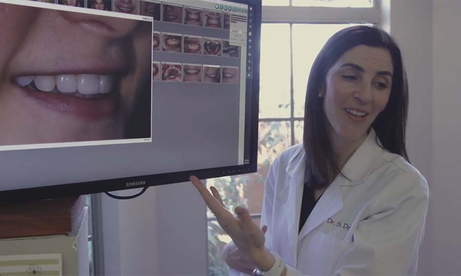 Covington Louisiana dentist showing a patient photos of their teeth on computer