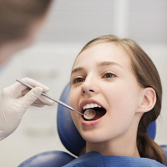 Girl having dental checkup done