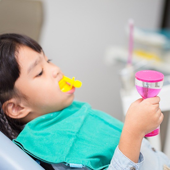 Young girl getting fluoride treatment