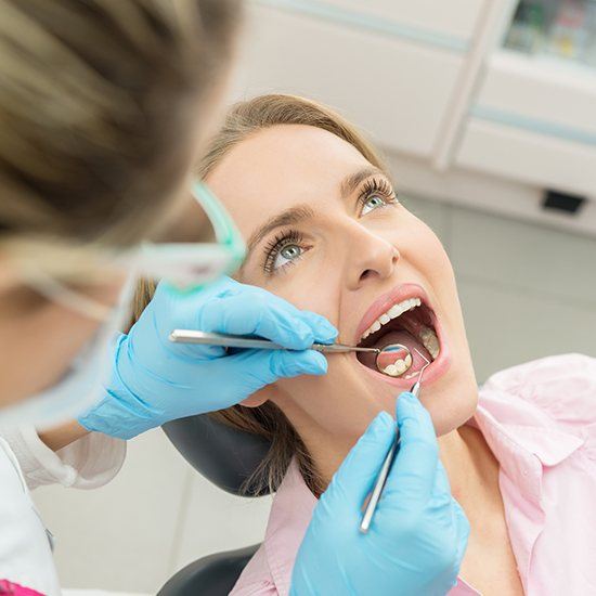 Woman having dental cleaning done
