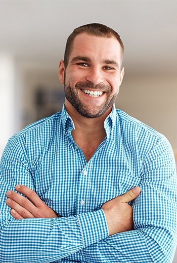 man crossing arms smiling