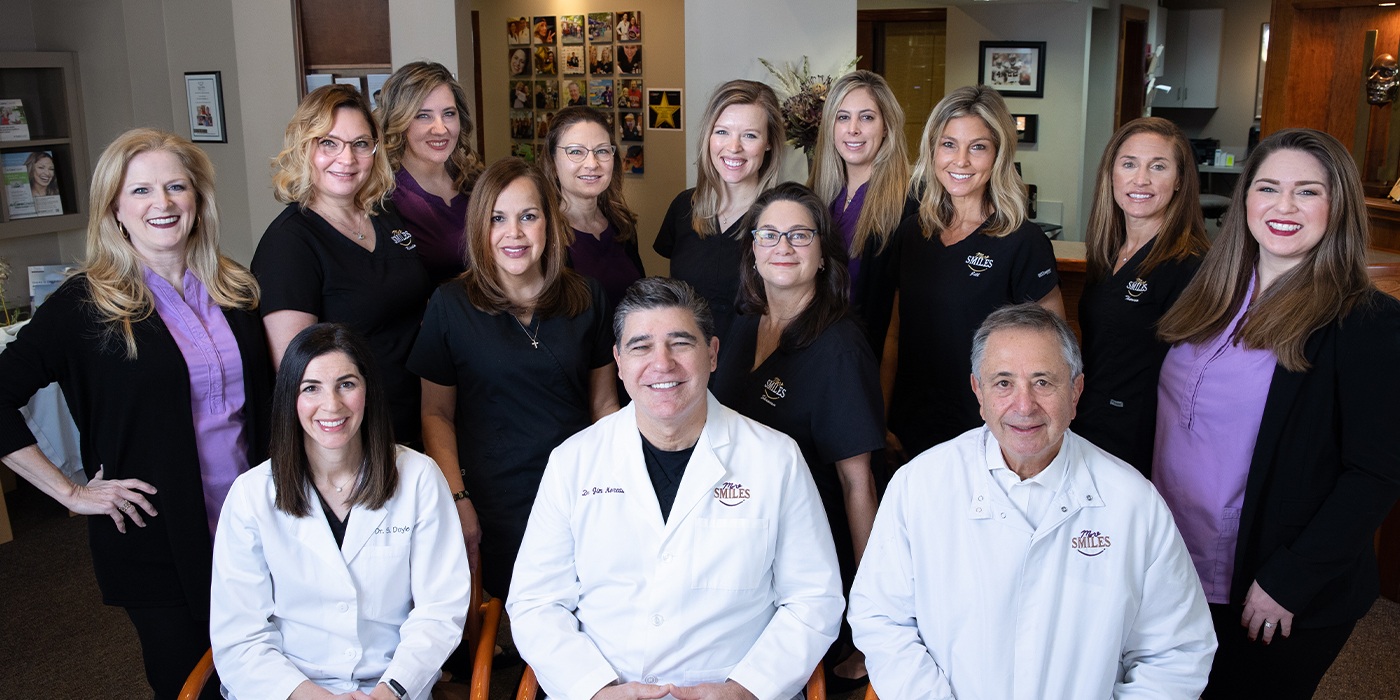 Covington dentists and dental team members posing in dental office reception area