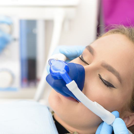 Woman relaxed with nitrous oxide dental sedation mask on