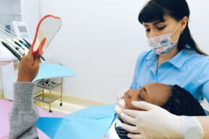 Woman in dental chair with hygienist 