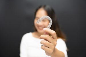 a woman showing teeth aligners