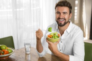man eating salad
